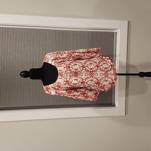 Red and white embroidered shirt. Three quarter length sleeve.